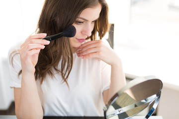 Woman applying make up