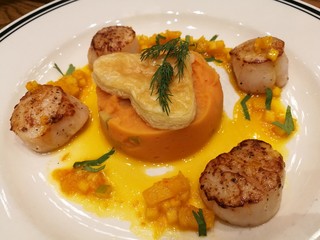 Pan fried seared Hokkaido scallop served with creamy mashed sweet potato and orange sauce top with heart pie. Special dish for celebrating Xmas, New year, Valentine, Ester, Thanksgiving and Party