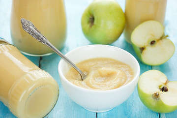 Green apple puree with fresh apples and apple puree in jars