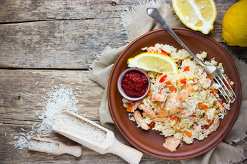Salmon rice pilaf with lemon and tomato sauce