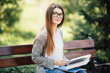 A shot of a college student reading a book on bench in park © F8  \ Suport Ukraine