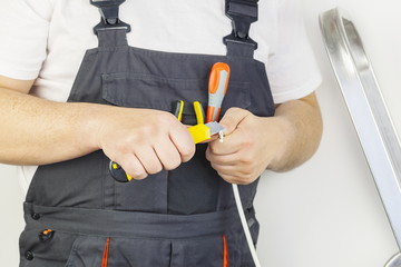 Worker with knife and cable close up