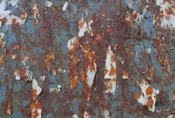 Rust texture with scraps of old paper, glued to the iron. Background of antiquity and destruction. Corrosion of metal. Rust on old wall background