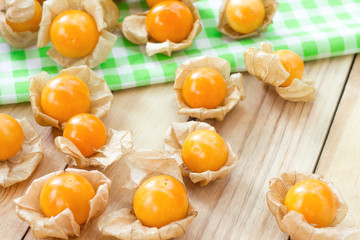 Golden berries or physalis fruit on wooden table