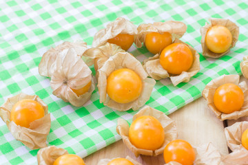 Golden berries or physalis fruit on wooden table