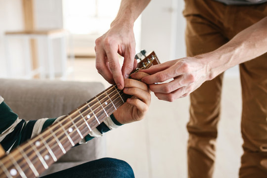 Learning to play the guitar. Music education.