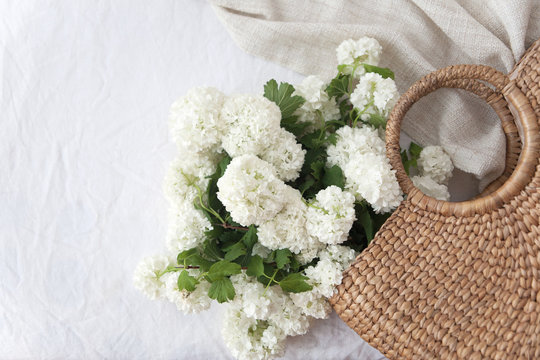 Straw bag and bunch of flowers
