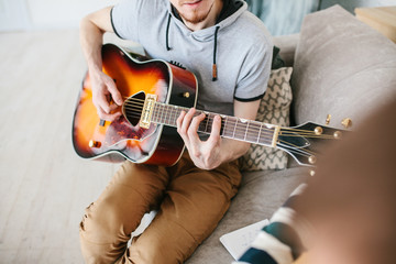 Learning to play the guitar. Music education.