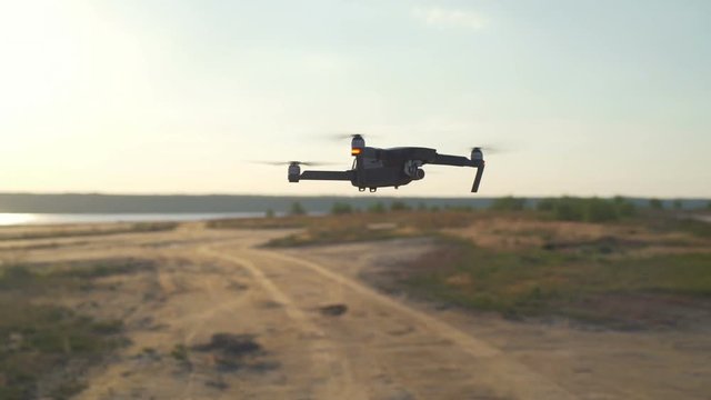 Alone quadrocopter flying upon a desert slow motion
