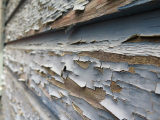 Peeling paint on wooden wall