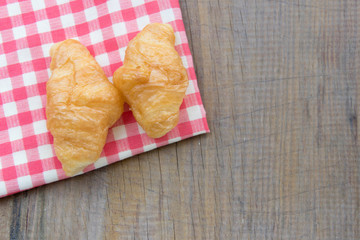 breakfast background. Close-up Croissant on plaid red napkin. high angle background