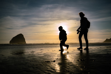 mother and child silhouette  at the beach