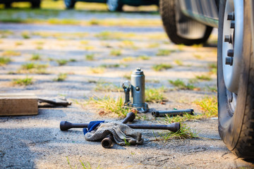 Socket wheel wrench and jack lying on ground