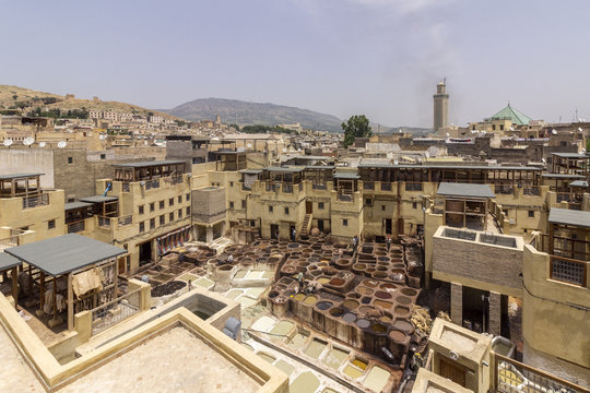 Fes el Bali city skyline and terrace view of the dye pots at leather traditional tanneries in the ancient medina, in Fez