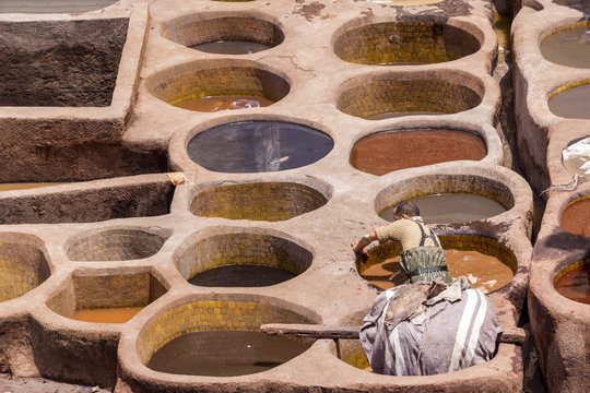 Fes el Bali worker the dye pots at leather traditional tanneries in the ancient medina, in Fez