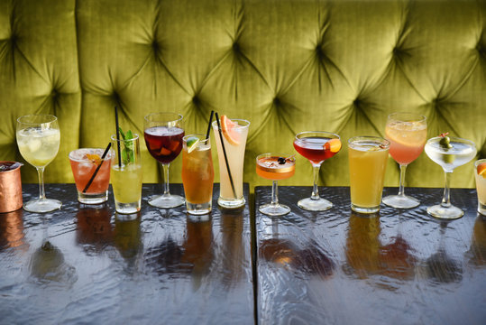 Row of various cocktails on table 