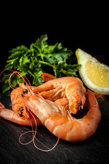 Shrimps for dinner on stone plate.