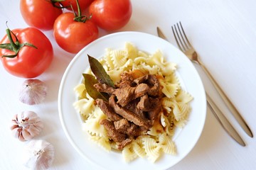 Pasta with beef in tomato sauce and laurel leaf spices 