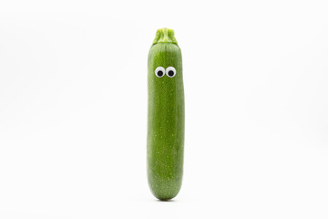 zucchini with googly eyes on white background