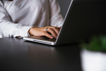 Closeup of business woman hand typing on laptop keyboard