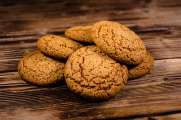 Stack of the oatmeal cookies on wooden table