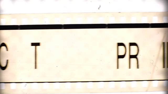 Movie film header reel moving on backlight viewer printer