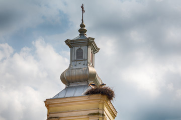 Naklejka premium Stork Nest on Church Rooftop