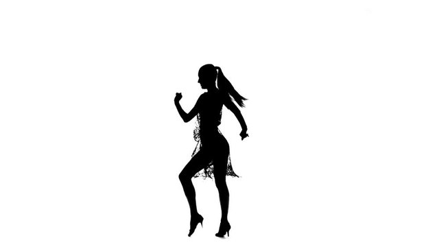 Solo woman dancing elements of ballroom dancing. Silhouette, slow motion