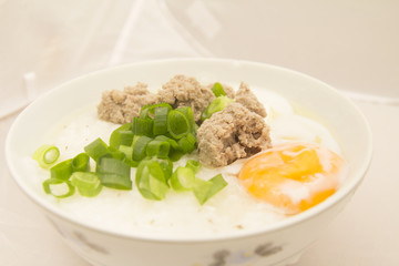 Porridge, eggs, pork chops, Traditional thai porridge rice gruel, tasty food.
