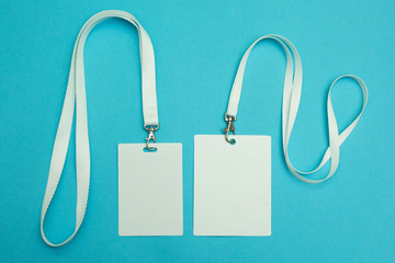 Two name tags on a blue background. Space for text and design.