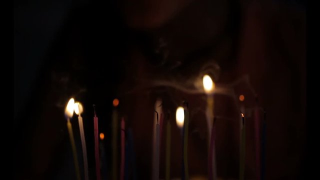Close up of a little girl blowing the candles