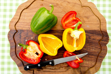 Peppers - Capsicum cut on wooden board - high angle view
