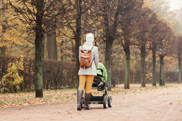 Mother walking in park with a stroller
