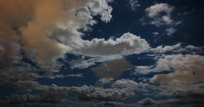 Cottony Clouds Drifting across the Starry Sky in Timelapse