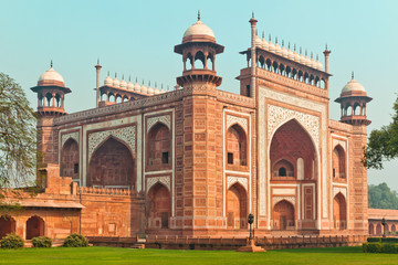 Fototapeta na wymiar Taj Mahal Main gateway building against blue sky in Agra, Uttar Pradesh. Red sandstone masterpiece