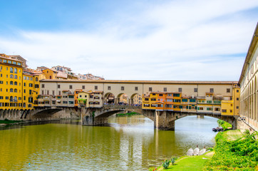 Fototapeta na wymiar Ponte Vecchio, Old Bridge, medieval stone arch bridge over the Arno River and with many small shops along it, Florence, Tuscany, Italy, Europe. UNESCO World Heritage Site