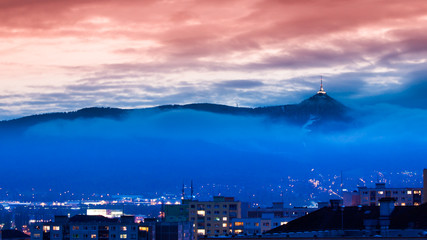 Illuminated Jested transmitter tower and hotel. Blue cloudy evening in Liberec, Czech Republic.
