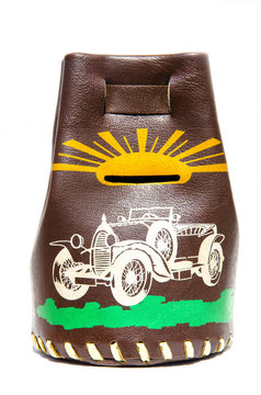Leather money-box with money for the image of an old car and the sun.