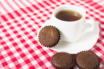 Mini muffins with cup of tea on tissue