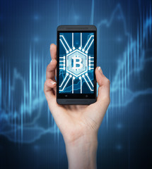 Woman s hand with bitcoin icon on smartphone