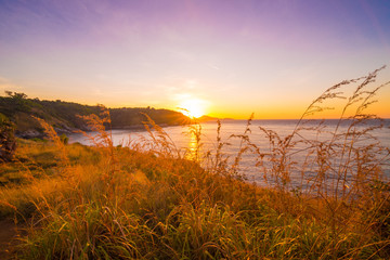Fototapeta premium Rocky sea beach sunrise blue sky with grass