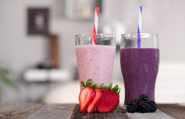 Milkshakes made with fresh blueberries and strawberries in a glass