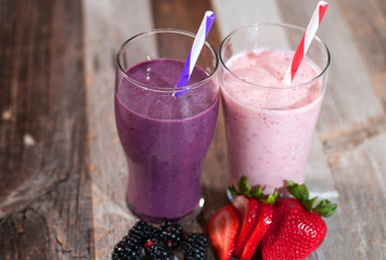 Milkshakes made with fresh blueberries and strawberries in a glass