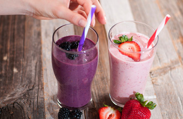 Milkshakes made with fresh blueberries and strawberries in a glass
