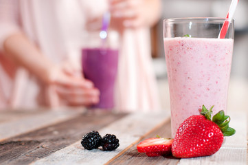 Glass of strawberry milkshake and strawberry