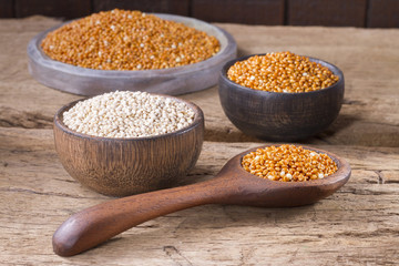 Quinoa grains and red millet on wood - Chenopodium quinoa