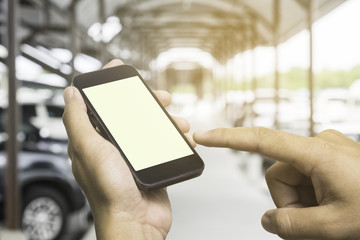 Use a smartphone with a blank screen, crowded parking lot.
