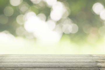 Brown grunge wooden floor with abstract blurred background in light green nature tone color. 