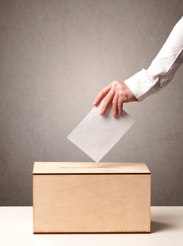 Ballot box with person casting vote