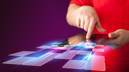 Close up of hand holding tablet with cyber application